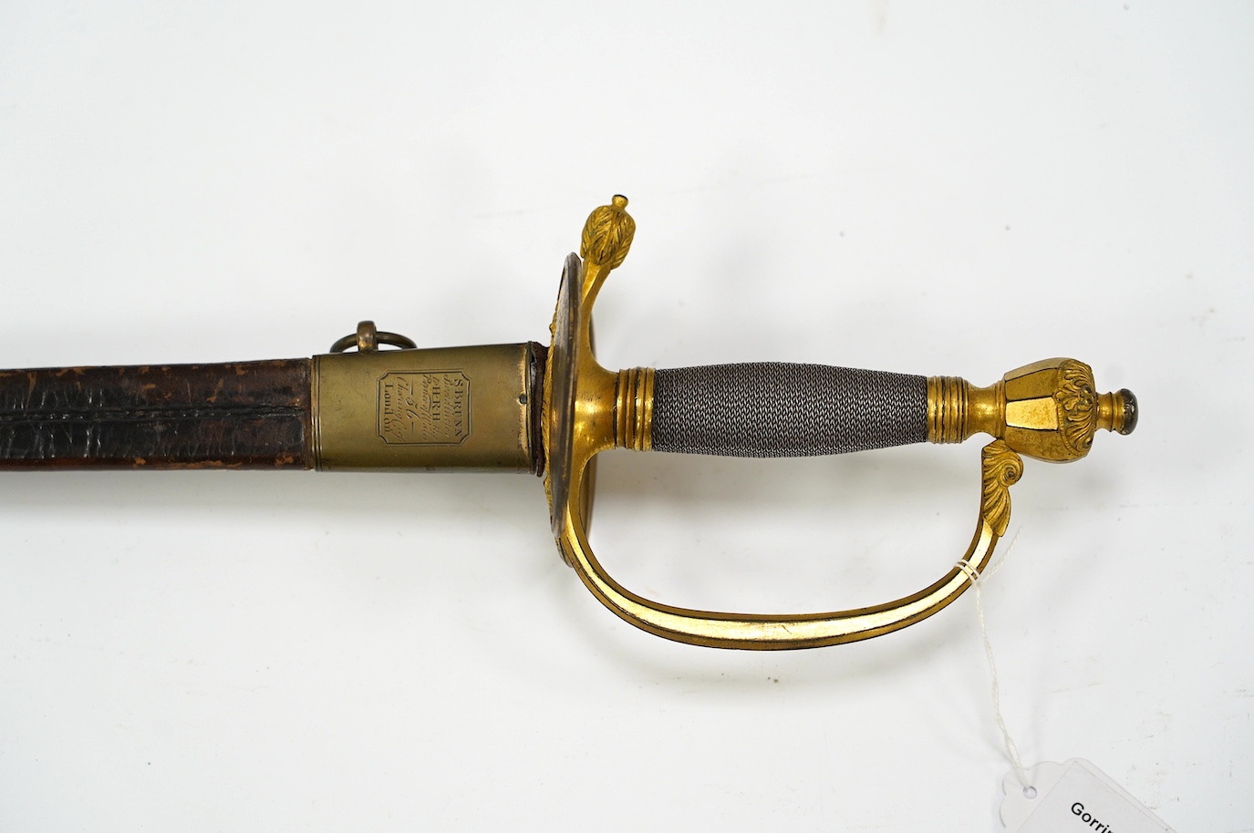 A 1796 pattern infantry officer's sword, blued and gilt blade, etched with crowned GR and Royal Arms, regulation gilt brass hilt, in its leather scabbard with brass mounts, locket signed S. Brunn, 81.5cm. Condition - goo